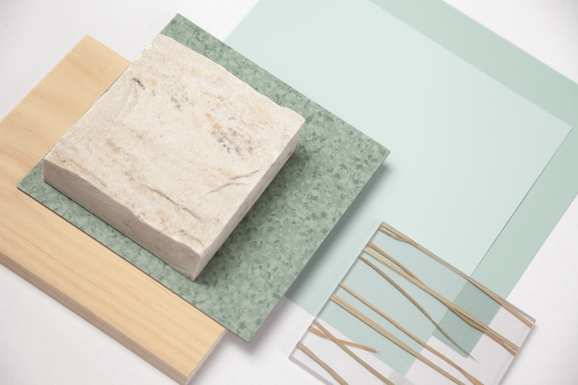 Sandstone block on green terrazzo, timber and mint laminate samples